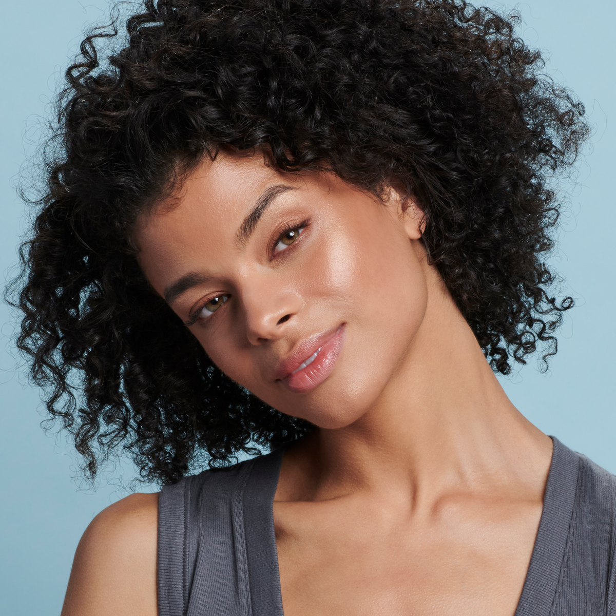 Model wearing Colorescience Face Shield Bronze SPF 50 for a sun-kissed glow