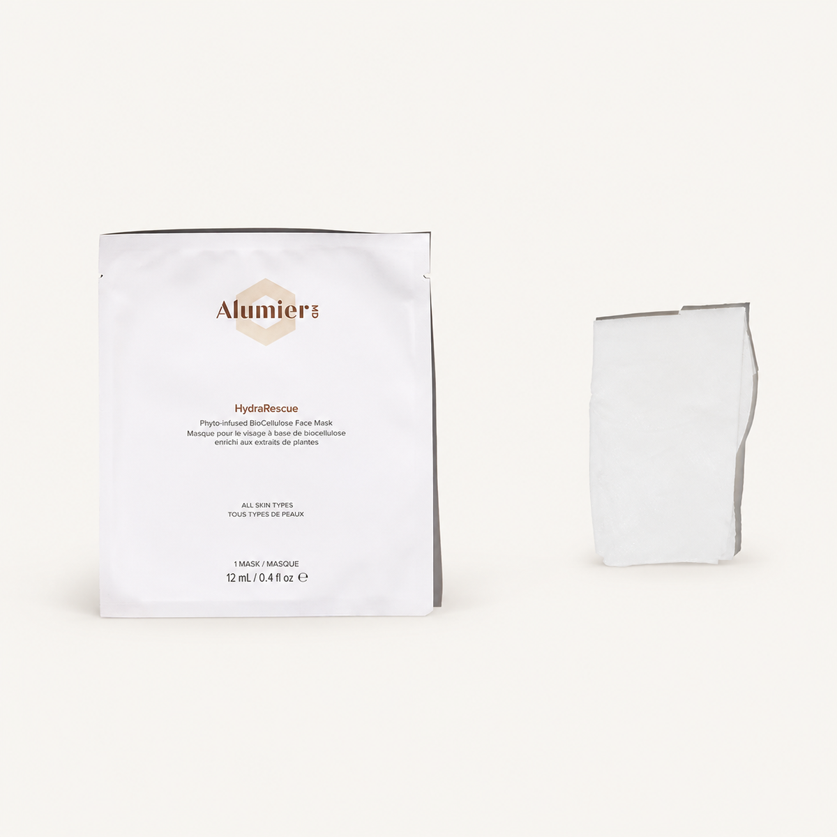 AlumierMD HydraRescue BioCellulose Face Mask single sachet and folded mask on a warm ivory background