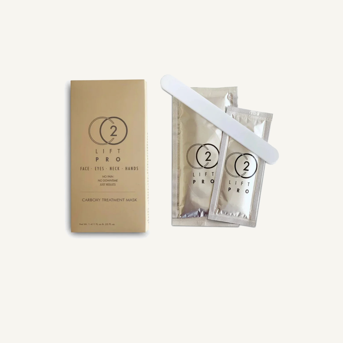 CO2Lift Pro Carboxy Gel Treatment Mask box, two gel packets and applicator on a warm cream background