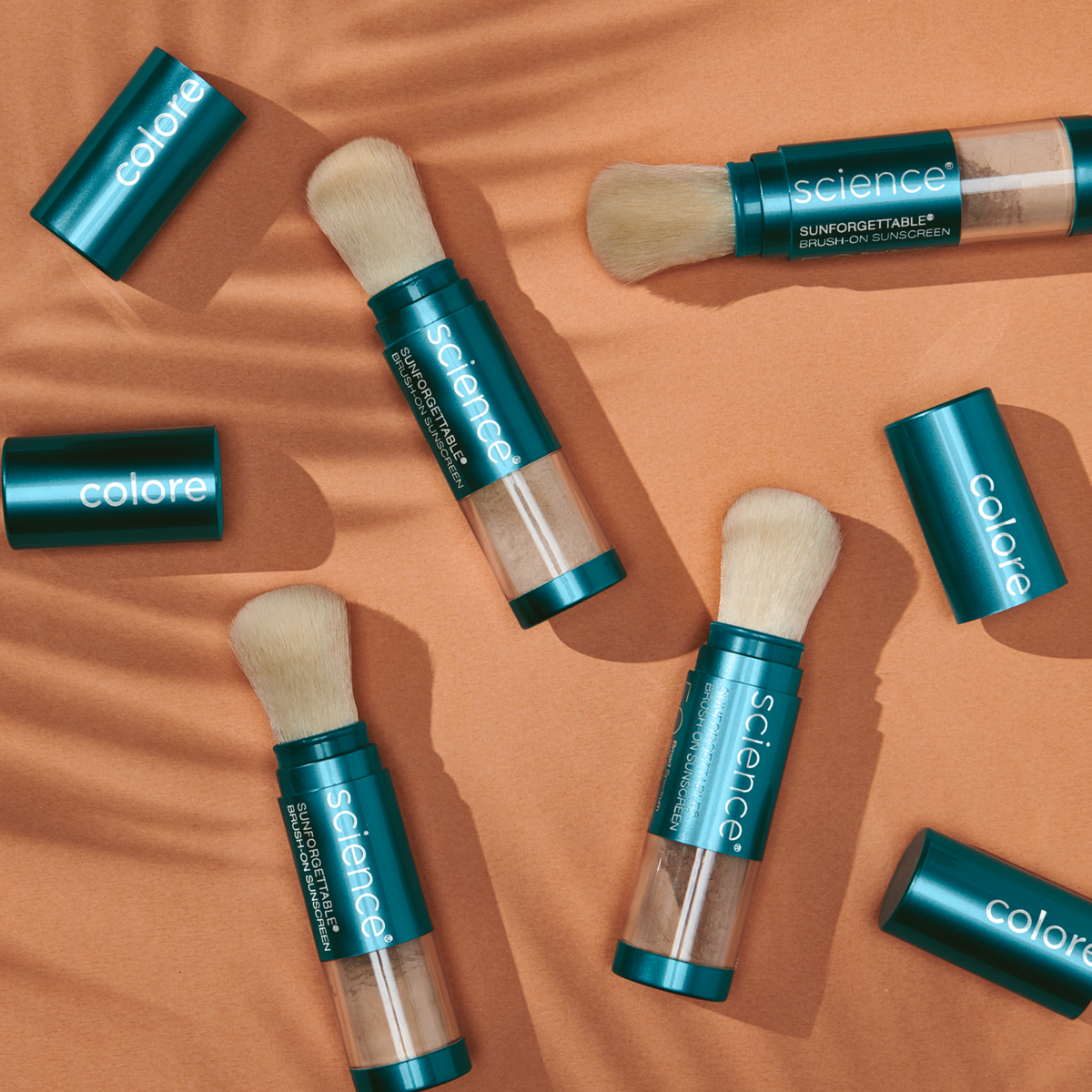 Colorescience Brush-On Shield SPF 50 powder sunscreen brushes on warm fabric