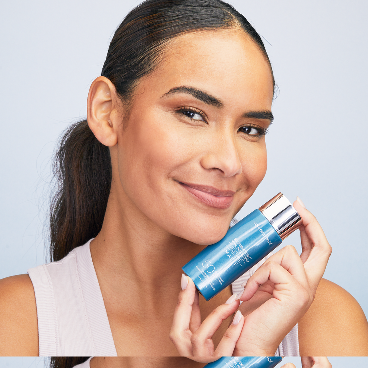 Model wearing Colorescience Face Shield Matte SPF 50 with a shine-free finish