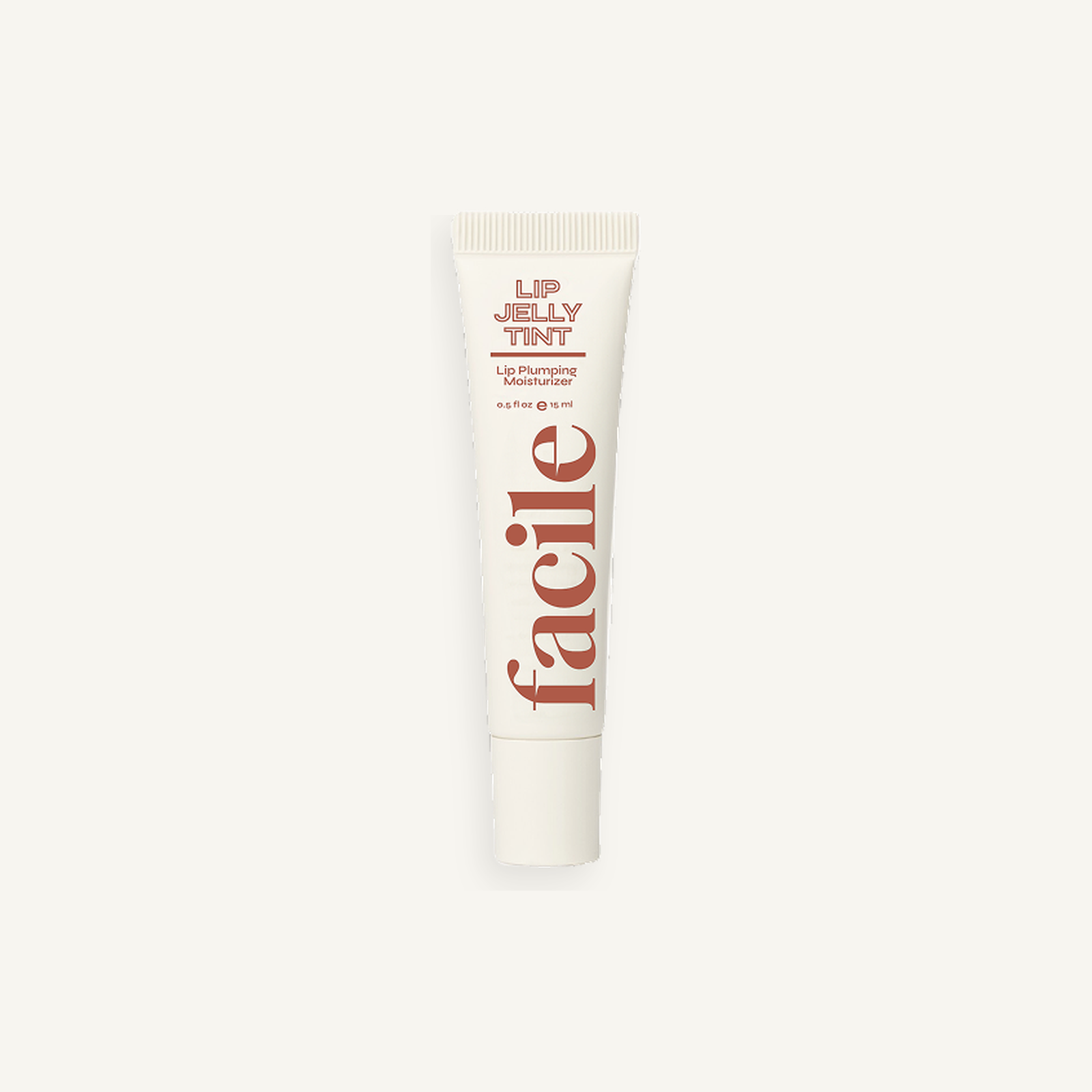 Facile Lip Jelly Cognac 15 mL tube on a warm cream background