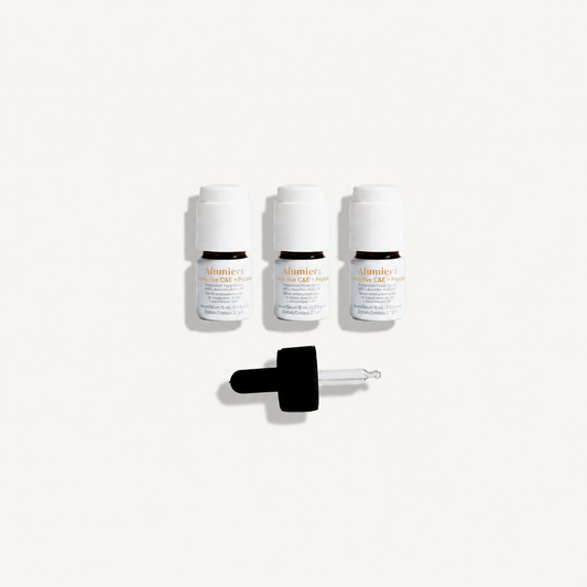 AlumierMD EverActive C&E + Peptide three-pack with dropper on a warm ivory background